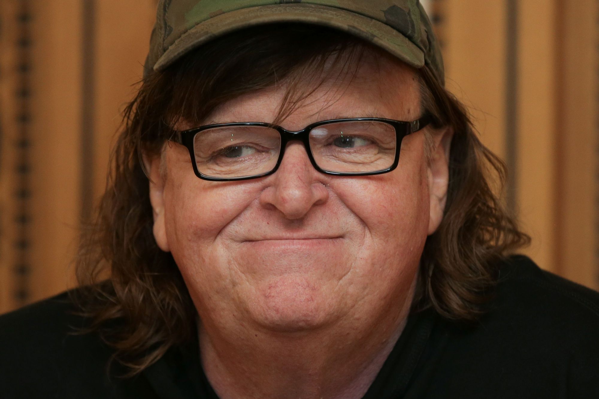 (FILES) This file photo taken on June 9, 2016 shows US filmmaker Michael Moore attending a photo call for his new film "Where To Invade Next" in London. In 2004, director Michael Moore took on George W. Bush in "Fahrenheit 9/11." On Tuesday, the filmmaker surprised his fans with news that he would debut his new film about Donald Trump. "Michael Moore in TrumpLand" will have a free pre-screening October 18, 2016 in New York, he announced on Twitter. The movie is apparently based on his failed efforts to stage a one-man show about Trump in an Ohio theater. Moore said it was cancelled because he was told he was too controversial. / AFP PHOTO / DANIEL LEAL-OLIVAS